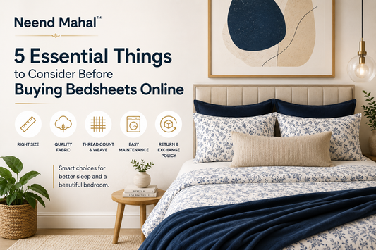 Elegant blue floral bedsheets with navy throw on modern bed, featuring premium fabric and cozy bedroom styling.